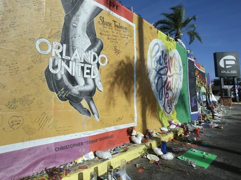 Artwork and signatures cover a fence around the Pulse nightclub, scene of a mass shooting, in Orlando, Fla. Noor Salman, widow of gunman Omar Mateen, is accused of aiding her husband's attack.
